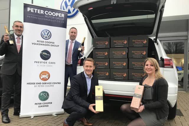 Darren Cooper, managing director of the Peter Cooper Motor Group, and Rebecca Fisher, from Hattingley Valley Wines, with staff