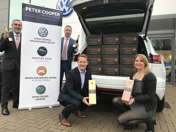 Darren Cooper, managing director of the Peter Cooper Motor Group, and Rebecca Fisher, from Hattingley Valley Wines, with staff