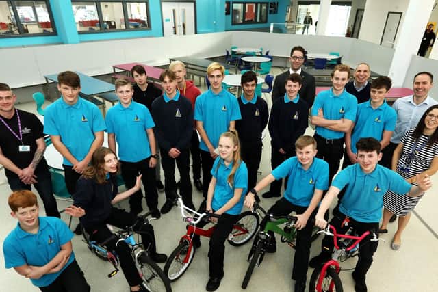 Pupils involved in the Recycle a Cycle project alongside Mike Evans of Southsea Cycles, left, and teacher Katy Le Gris, right  Picture: Chris Moorhouse