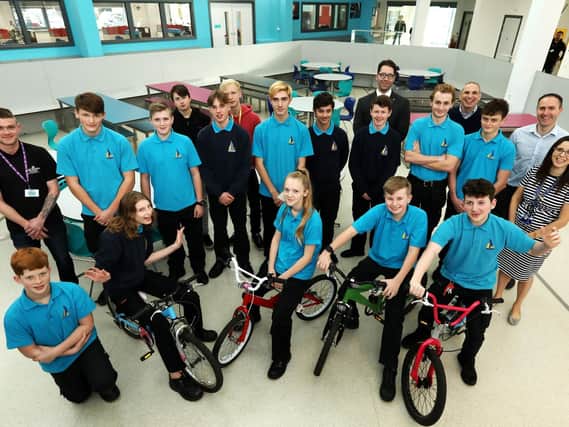 Pupils involved in the Recycle a Cycle project alongside Mike Evans of Southsea Cycles, left, and teacher Katy Le Gris, right  Picture: Chris Moorhouse