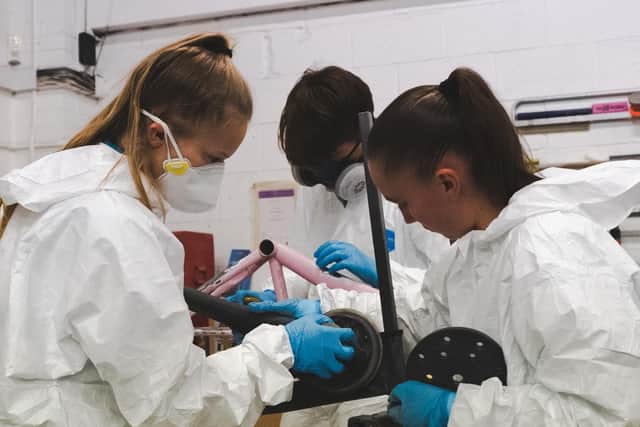 Students work on restoring the bikes.