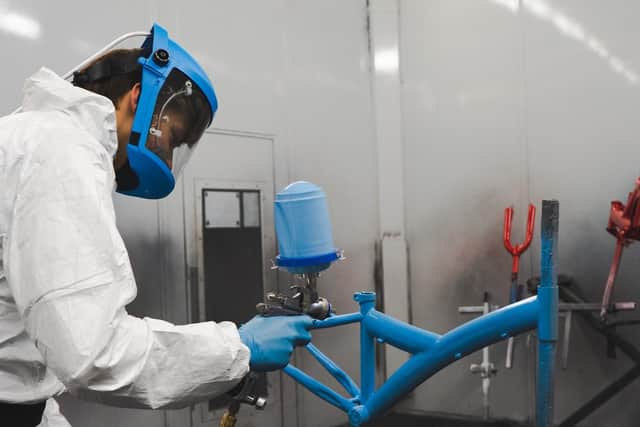 Students re-spraying the bikes at Apollo Motor Group
