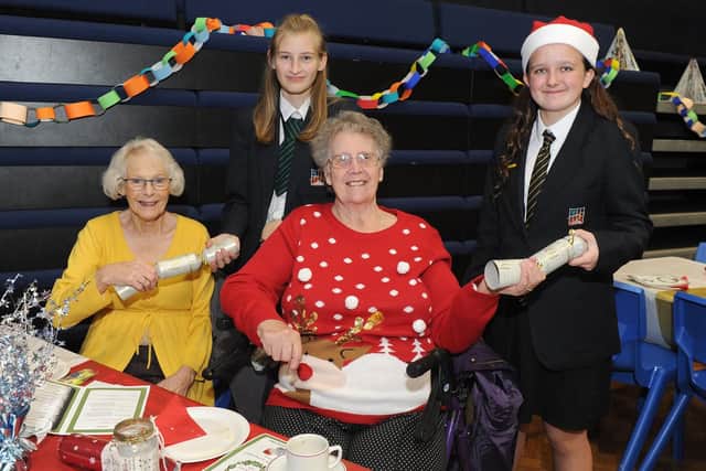 Pulling a cracker, Jenny Ranhall, Katie Mundy 13, Doreen Hammacott and Harmony Storey 12. The Henry Cort Community College students are organising our 30th anniversary Senior Citizen's Christmas Party
Picture: Habibur Rahman