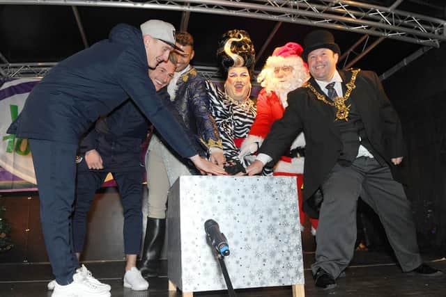 70,500: The switch was flicked on Christmas lights in Commercial Road, Portsmouth. From left, Portsmouth FC players Ronan Curtis and Craig MacGillivray, panto stars Jake Quickenden and Jack Edwards, Father Christmas and The Lord Mayor of Portsmouth Lee Mason. Picture:Sarah Standing (180845-2001)