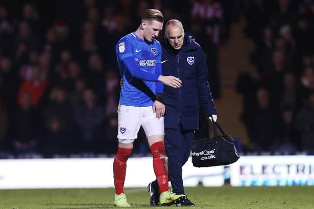 Ronan Curtis is escorted off the pitch during Pompey's 3-1 win against Sunderland Picture: Joe Pepler