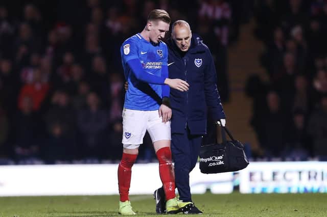 Ronan Curtis is escorted off the pitch during Pompey's 3-1 win against Sunderland Picture: Joe Pepler