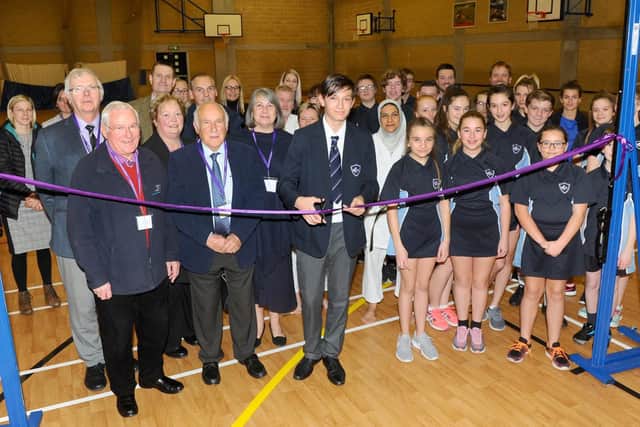 Bailey King officially unveils the new sports hall floor with councillors, staff and pupils.
Picture: Sarah Standing (180878-3972)
