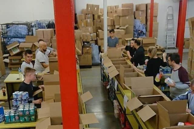 Staff and students from Park Community School work to put together Christmas food hampers.