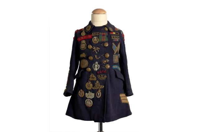 Betty Whites duffle coat. Bettywas a five-year-old girl living in Gosport who collected more than 90 badges from the differentregiments preparing for D-Day.