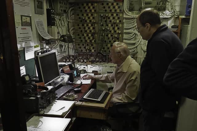 Club members Doug Hotchkiss and Frank Cotton operate radio equipment on a club visit to HMS Belfast which is moored in the Thames.