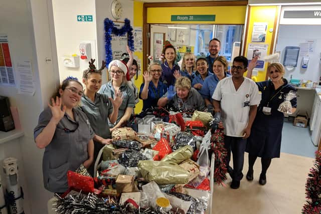 Sister Sandy Dewis, far right, collected almost 300 presents for patients on the orthopaedic trauma ward. She handed them out to patients with colleagues