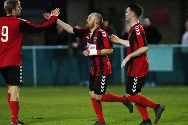 Scott Hamilton, centre, celebrates his goal in Fareham's win over Bashley. Picture: Chris Moorhouse
