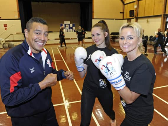 Q Shillingford, left, instructs Millie Lawrence and Malvina Price at the launch event for the new Heart of Hayling Boxing Club, in funded by the Lions. Picture: Ian Hargreaves