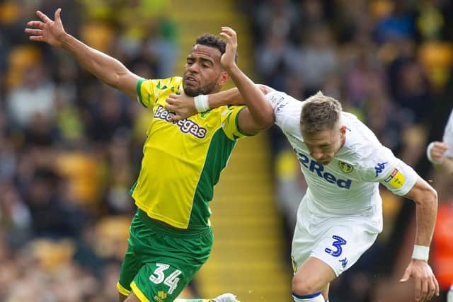 Norwich City's Louis Thompson battles with Leeds United's Barry Douglas. Picture: Mark Pain/ PA