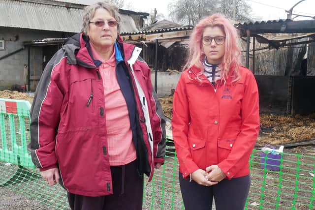 Stable owner Denise Hillman with Amelia Norman, who rents out space for two of her horses, in front of the burnt stables. Picture: Habibur Rahman (030119)