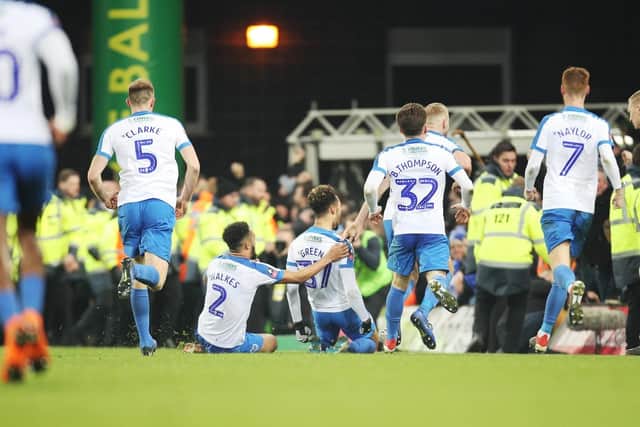 Andre Green is mobbed by Pompey's players following his Norwich match winner. Picture: Joe Pepler