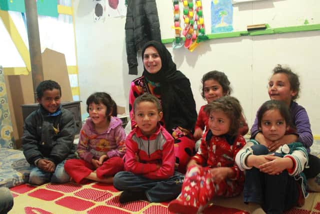 Syrian refugee children being taught in a tent school built by the charity Children on the Edge.