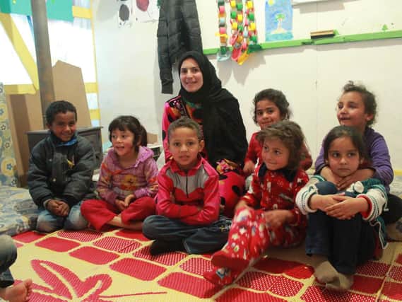 Syrian refugee children being taught in a tent school built by the charity Children on the Edge.