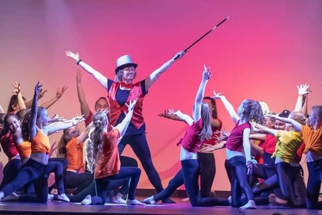 Su Killeen on stage with her gymnasts. Picture: Gordon Ford
