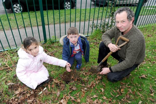 From left, Ravelyn Smith, four, and William Rogers, five, along with volunteer Adey Gardenier get ready to plant their first tree
Picture: Sarah Standing (110119-5582)