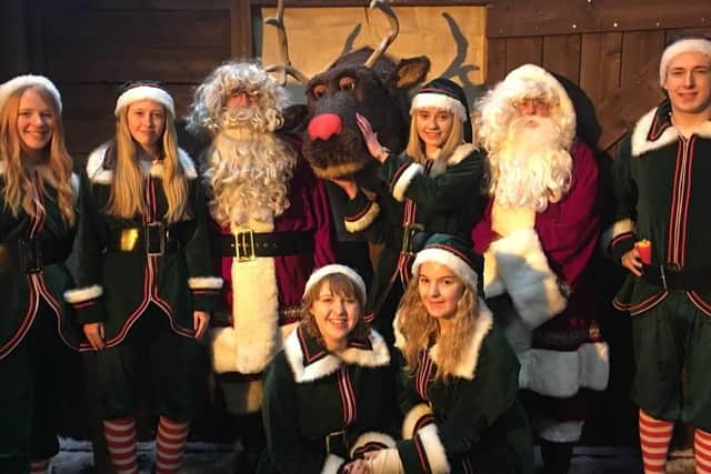 The staff of Gunwarf Express Christmas Grotto. Lara Kells, 15, is holding the reindeer.