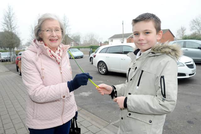 Aden Liotta, 11, gives a daffodil to Sylvia Longhurst from Denmead
Picture: Sarah Standing (210119-6487)