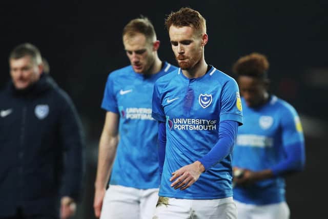The Pompey players leave the pitch at the Kassam Stadium Picture: Joe Pepler