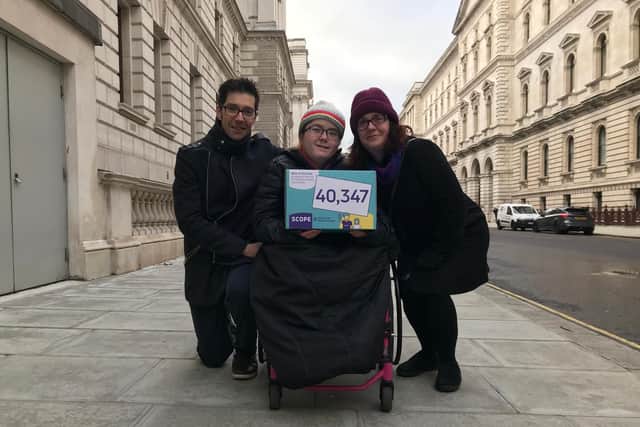 Dan White, Emily White and Aimee White with the Scope petition calling for the appointment of a minister for disabled children and families. Picture: Byron Melton