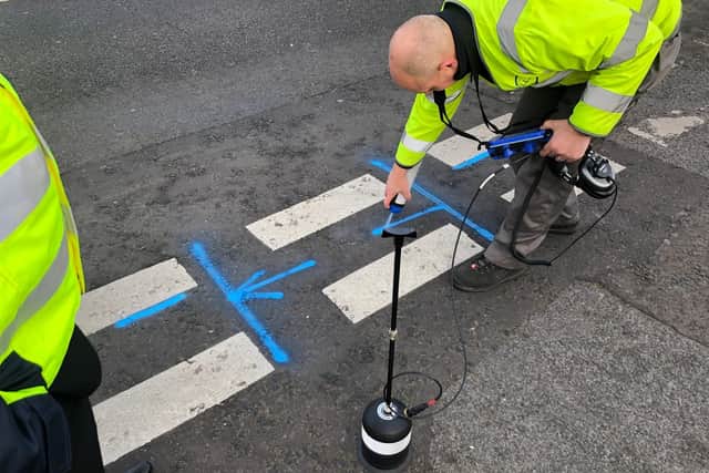 Network leak specialist Andy Mackenzie marks out the exact location of the pipe leak, after using two acoustic sensors and a ground microphone to determine its whereabouts at the junction of Goodwood Close, near Park Lane, Waterlooville.