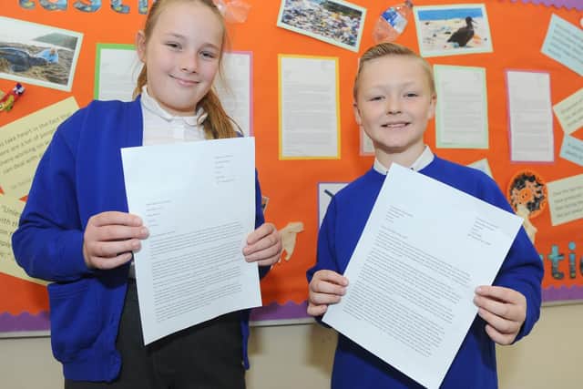 Delilah Brenton (11) and Ben Chinnery (10) with their letters to sent to companies to reduce their single use plastics. Picture: Sarah Standing (290119-7573)