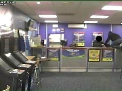 Armed robber threatens bookie staff captured on CCTV. Picture: Hampshire Constabulary
