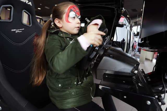 Morgan Knight, 6, having fun on the rally car simulator game. 
Picture: Chris Moorhouse           (260119-2)