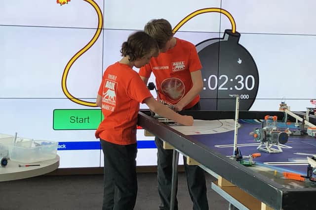 From left, Agile Supernova team members Joshua Stanning and Ian Colwell battle against the clock at the First Lego League regional heat at the University of Portsmouth. Picture: Liz Stoneham