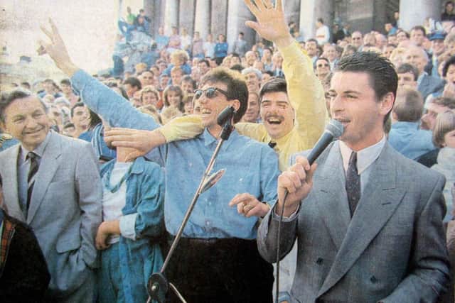Mick Kennedy takes to the stage with an Irish ballad with backing singers Paul Mariner, left, and Mick Quinn following Pompey's promotion in 1987