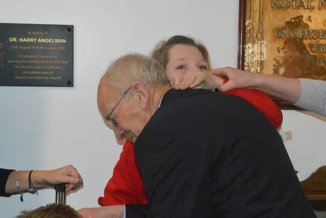 Nicole Dobbs (11) hugs Peter Patterson after he successfully campaigned for a plaque to Dr Harry Angelman to be installed in Gosport. Nicole has Angelman Syndrome herself, as did Peter's late son Anthony. Picture: David George