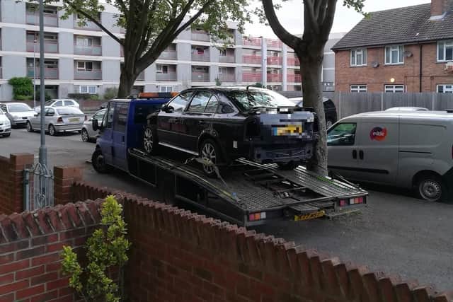 A vehicle recovery truck parked on pavement outside Mr Davison's house.