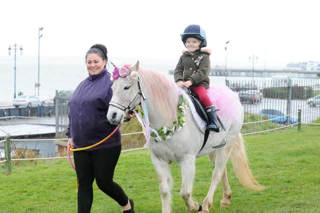 Isabella Bulman (three) of Hilsea, smiles as she rides Princess the Unicorn. Pictured with Clare Ward, leading Princess.
Picture: Sarah Standing (180219-1357)