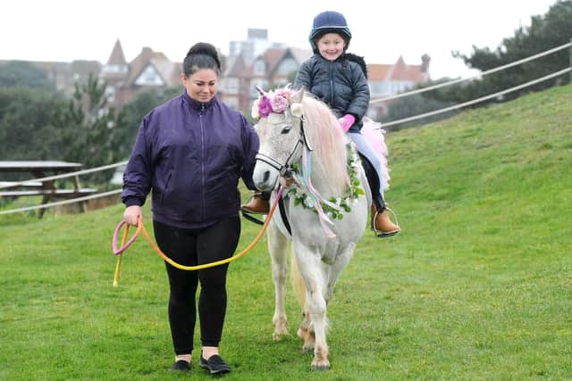 Tilly Poulter, five, of Swanmore, grins as she rides Princess the Unicorn. Pictured with Clare Ward.
Picture: Sarah Standing (180219-1338)