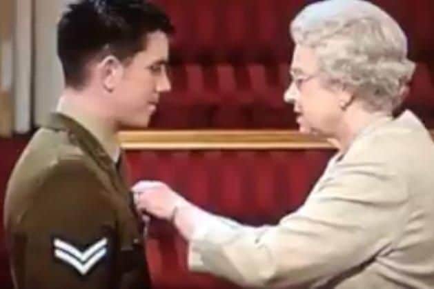 Brian Wood receives his Military Cross from the Queen after his heroic actions in Iraq.