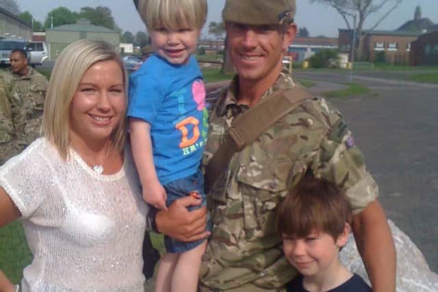 Brian Wood pictured with his wife, Lucy, and their sons Bailey, right, and Charlie, left, after he came back from Afghanistan in 2012.