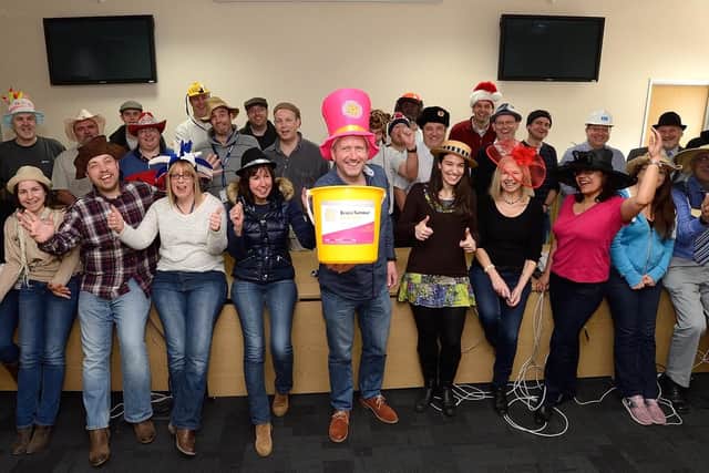 Simon Tier, middle, and the crew from Airbus celebrating Wear A Hat Day. Picture: Brain Tumour Research