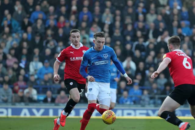 Ronan Curtis is challenged for the ball