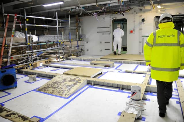 Workers at Babcock's, Rosyth shipyard, in Scotland, work to assemble the separate pieces of HMS Queen Elizabeth together in December 2012. Picture: Allan Hutchings (123920-279)