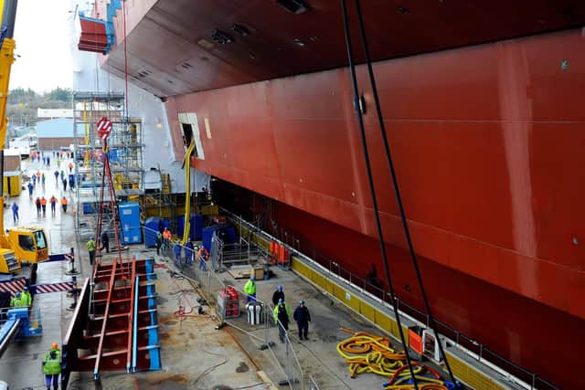 Ship builders in Rosyth worked to put together the separate pieces of HMS Queen Elizabeth which had been built across the country, including in her future home Portsmouth. Picture: Allan Hutchings (123920-260)