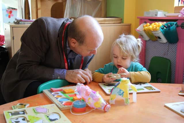 Councillor Simon Martin with Alice from Woodlands Early Roots nursery,