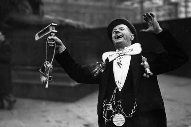 Pompey supporter decked in gear cheering the team on in Trafalgar Square before their FA Cup Final trophy over Wolverhampton Wanderers in April 1929.