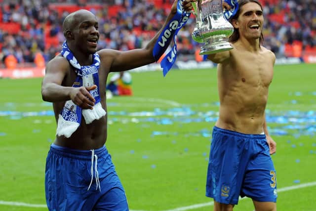 Pedro Mendes and Lassana Diarra celebrate with the FA Cup after Pompey beat Cardiff.