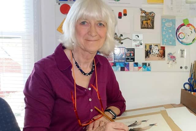 Marian Forster, a founder member of the arts trail, painting in her studio.