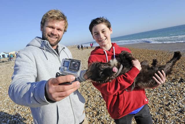 Kitesurfer Sam Light, left, is reunited with the GoPro camera he lost on the waves off Hayling Island in 2014 - thanks to Dionne Hibbs and her son Joshua, right, who found it during a walk along the beach with the dog, Belle. Picture: Ian Hargreaves  (240219-2)