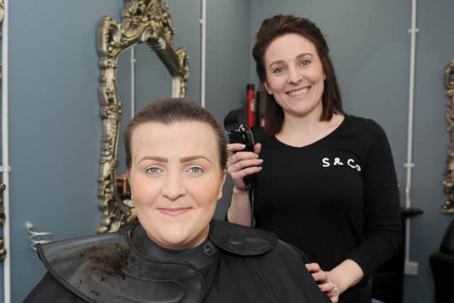 Jamie Sheppard, owner of Sheppard & Co hairdressing with Nadine Gofton from Portsmouth, who did a Brave the Shave fundraiser for Macmillan on Jamie's opening day.
Picture: Sarah Standing (010319-529)